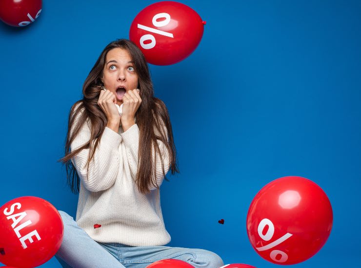 Una ragazza tra palloncini con sconti